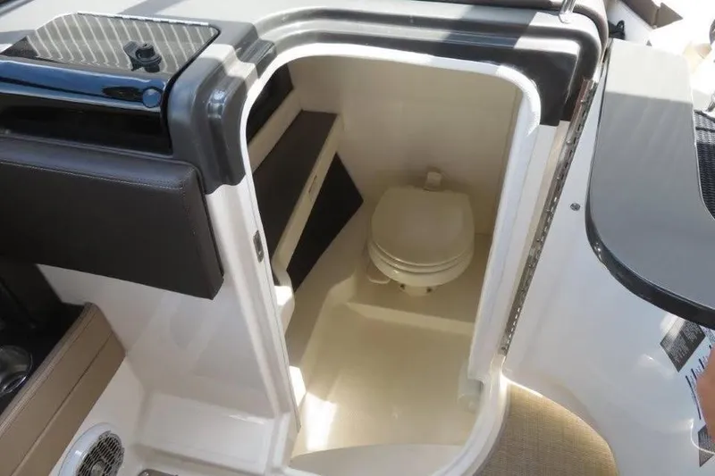 Slide: The Image of Interior view of 2016 Sea Ray 280 SLX boat's compact bathroom with toilet. - 8