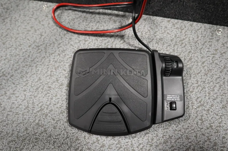 Slide: The Image of Minn Kota foot pedal on 2026 Lowe Fishing Machine 175 boat, gray carpet background. - 13
