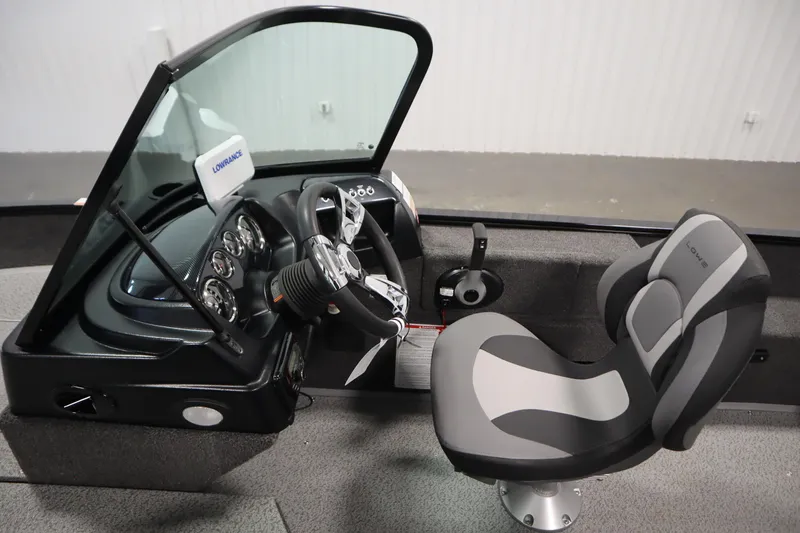 Slide: The Image of 2026 Lowe Fishing Machine 175 cockpit with steering wheel, gauges, and comfortable seat. - 22