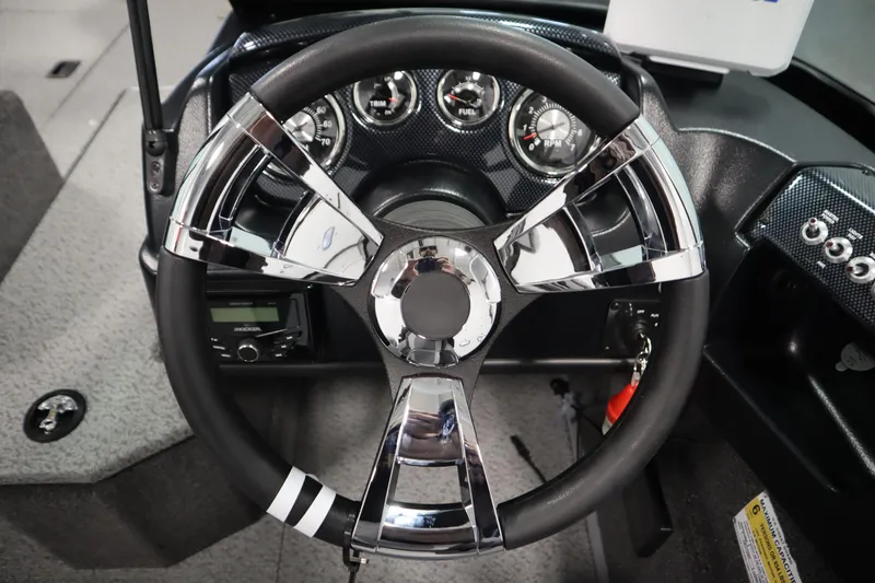 Slide: The Image of 2026 Lowe Fishing Machine 175 dashboard with chrome steering wheel and gauges. - 24