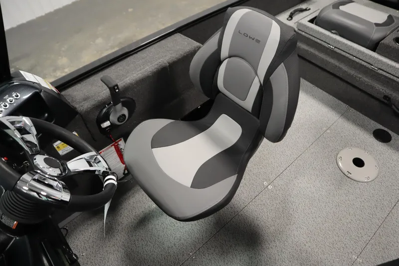 Slide: The Image of 2026 Lowe Fishing Machine 175 interior with steering wheel and cushioned seat. - 31