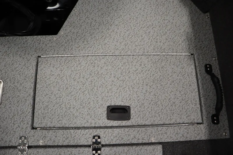 Slide: The Image of 2026 Lowe Fishing Machine 175 boat storage compartment with textured gray surface. - 40