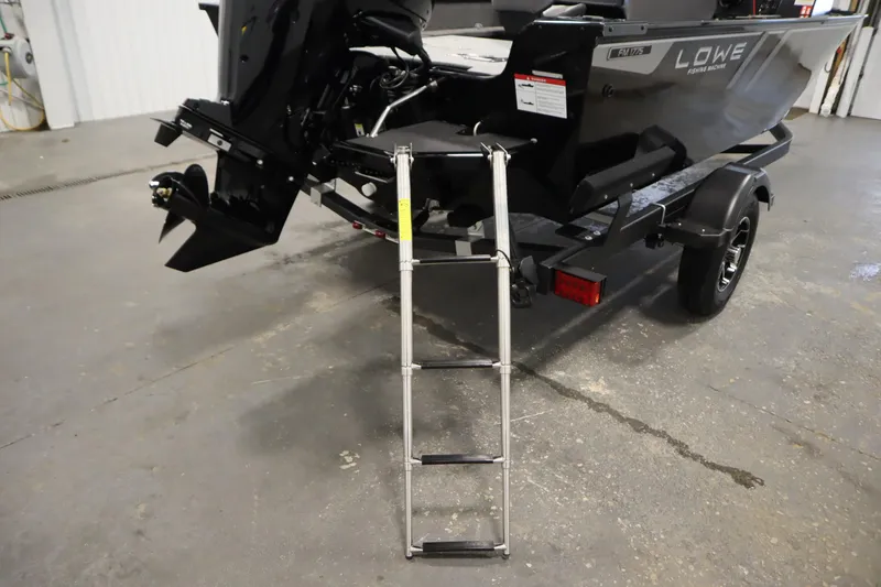 Slide: The Image of 2026 Lowe Fishing Machine 175 boat with ladder and trailer in a garage. - 42
