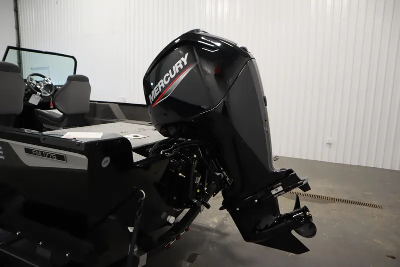 Slide: The Image of 2026 Lowe Fishing Machine 175 with Mercury outboard motor in a showroom. - 44