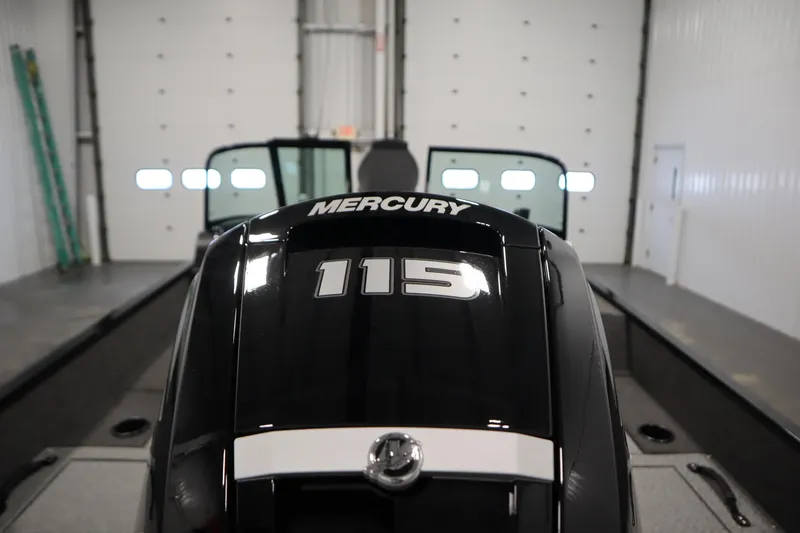 Slide: The Image of 2026 Lowe Fishing Machine 175 with Mercury 115 engine in a garage setting. - 45