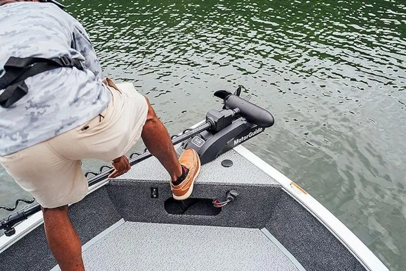 Slide: The Image of Man on 2026 Lowe Fishing Machine 175 boat, adjusting MotorGuide trolling motor. - 53