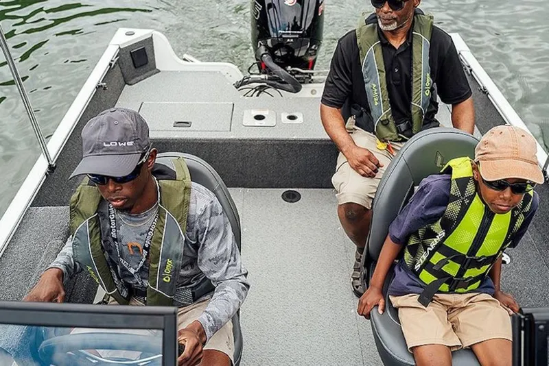 Slide: The Image of 2026 Lowe Fishing Machine 175 with three people onboard, wearing life jackets, on a lake. - 56