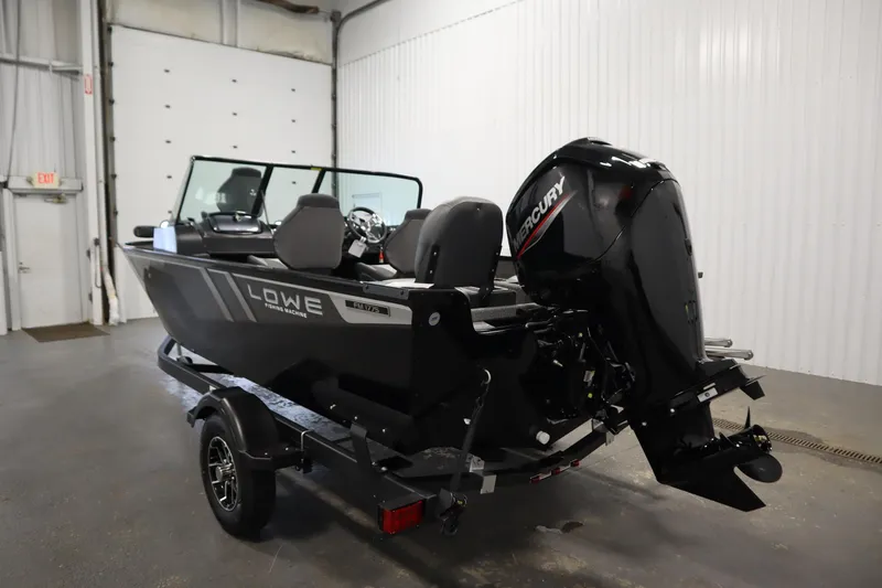 Slide: The Image of 2026 Lowe Fishing Machine 175 boat with Mercury outboard motor in a garage setting. - 6