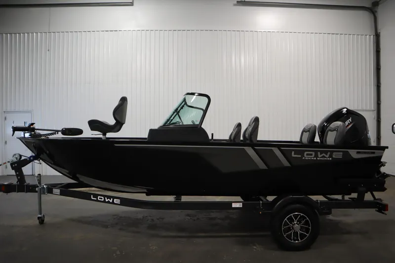 Slide: The Image of 2026 Lowe Fishing Machine 175 boat in a showroom, side view on trailer. - 7