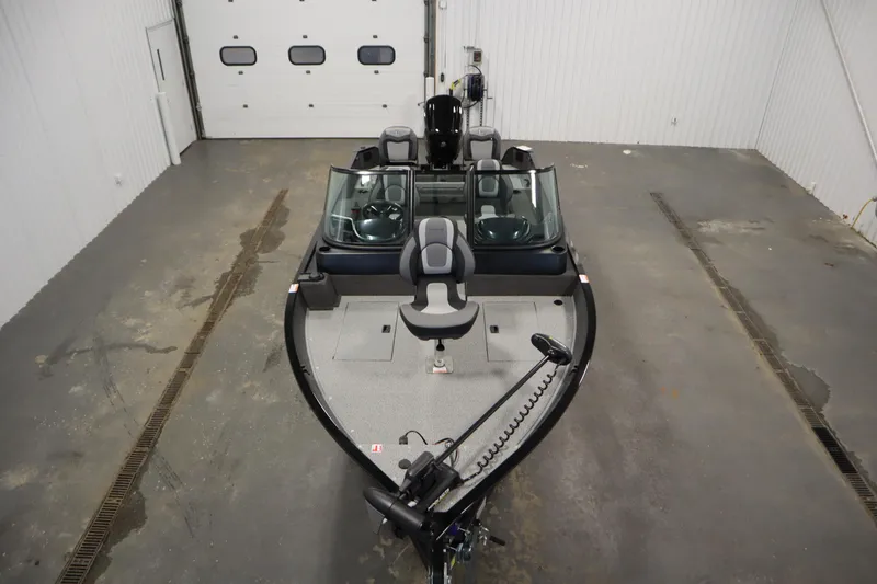 Slide: The Image of 2026 Lowe Fishing Machine 175 in a garage, showcasing sleek design and spacious interior. - 8