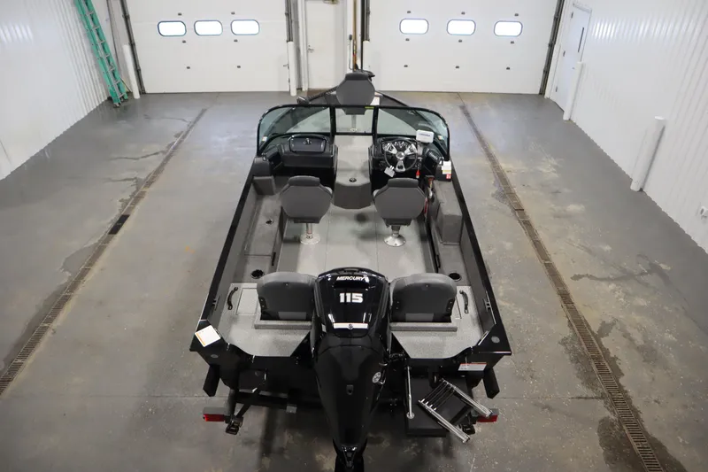 Slide: The Image of 2026 Lowe Fishing Machine 175 in a garage, showcasing interior and motor. - 9