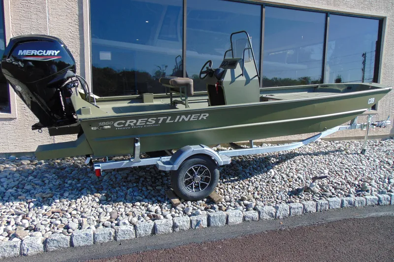 The Image of 2026 Crestliner 1860 Retriever CC boat with Mercury engine on trailer. - 1