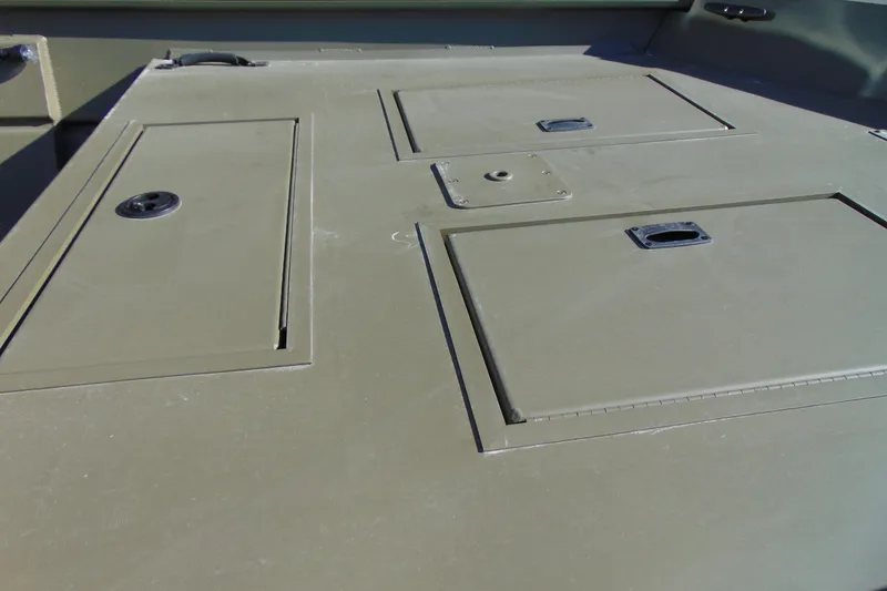 Slide: The Image of 2026 Crestliner 1860 Retriever CC boat deck with storage compartments. - 10