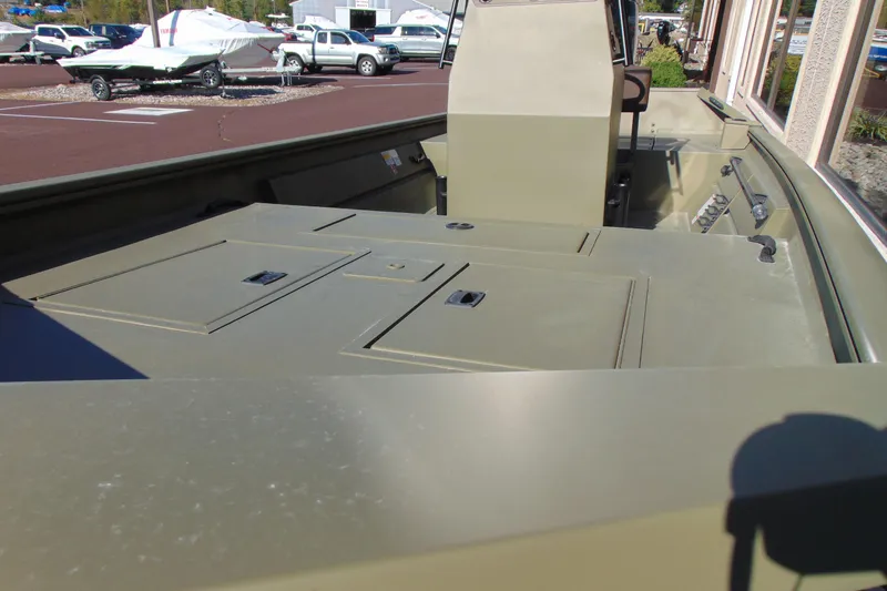 Slide: The Image of 2026 Crestliner 1860 Retriever CC boat interior with storage compartments and console. - 11