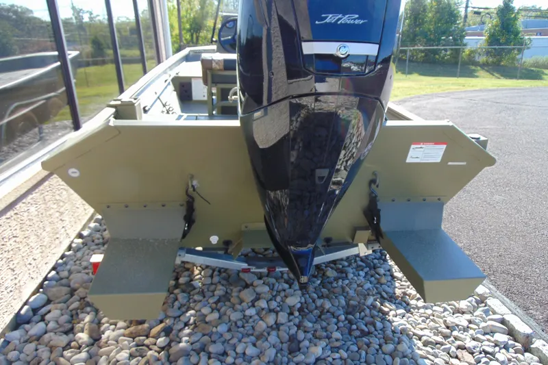 Slide: The Image of 2026 Crestliner 1860 Retriever CC boat with powerful jet engine, parked on gravel. - 4