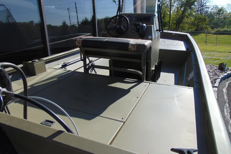 Slide: The Image of 2026 Crestliner 1860 Retriever CC boat interior with steering console and seating. - 6