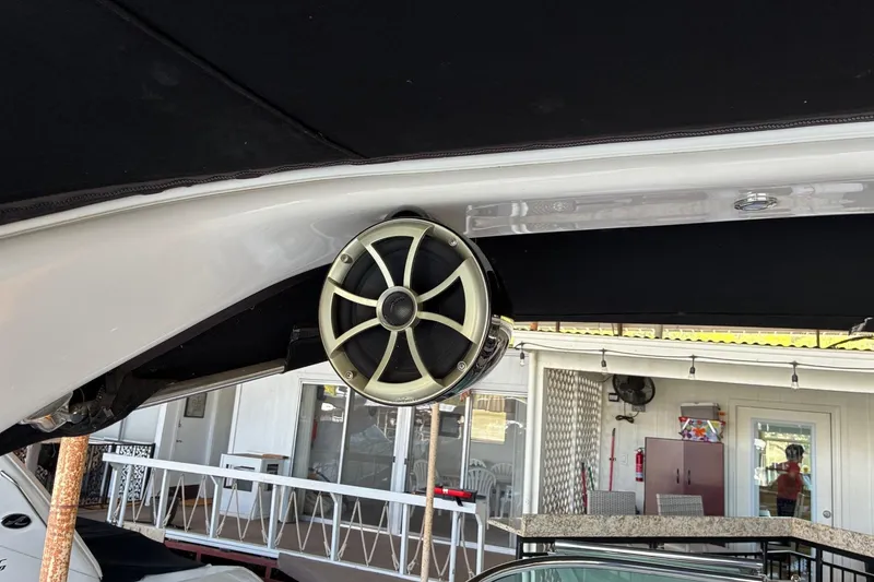 Slide: The Image of 2014 Regal 2500 Bowrider boat with mounted speaker under black canopy. - 10