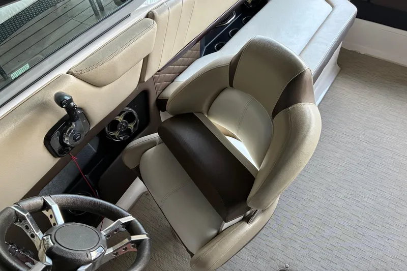 Slide: The Image of 2014 Regal 2500 Bowrider interior with steering wheel and beige seating. - 13