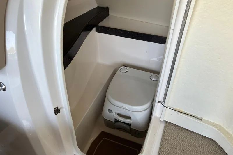 Slide: The Image of 2014 Regal 2500 Bowrider boat interior with compact portable toilet. - 14