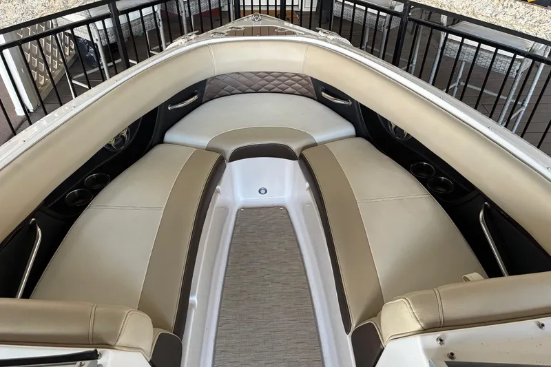 Slide: The Image of 2014 Regal 2500 Bowrider interior with beige seating and cup holders. - 15