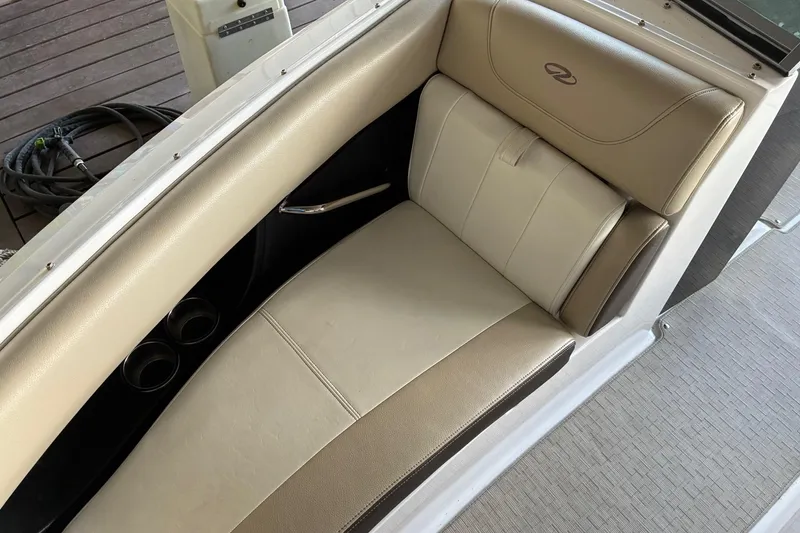Slide: The Image of 2014 Regal 2500 Bowrider interior seating with beige upholstery and cup holders. - 16