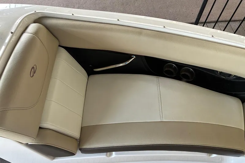 Slide: The Image of 2014 Regal 2500 Bowrider interior seating with beige upholstery and cup holders. - 17