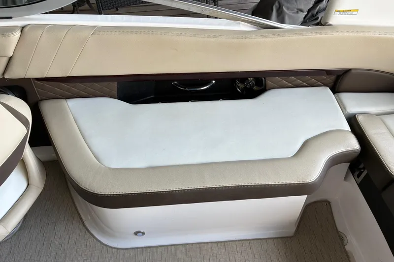 Slide: The Image of 2014 Regal 2500 Bowrider interior seating with beige and brown upholstery. - 18