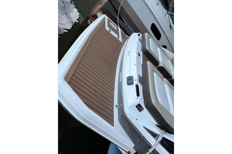 Slide: The Image of 2014 Regal 2500 Bowrider boat with teak-style swim platform and cushioned seating. - 19