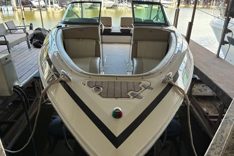 Slide: The Image of 2014 Regal 2500 Bowrider boat docked at marina, front view. - 2