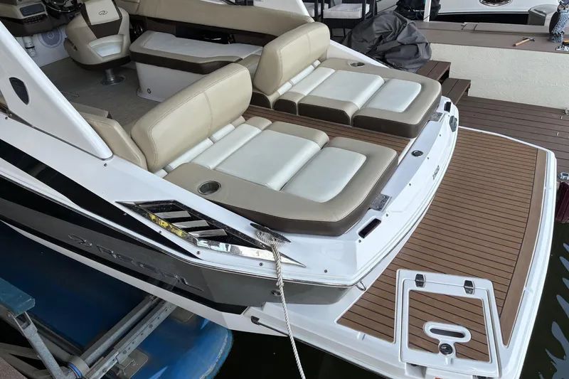 Slide: The Image of 2014 Regal 2500 Bowrider boat with beige seating and wooden deck. - 3