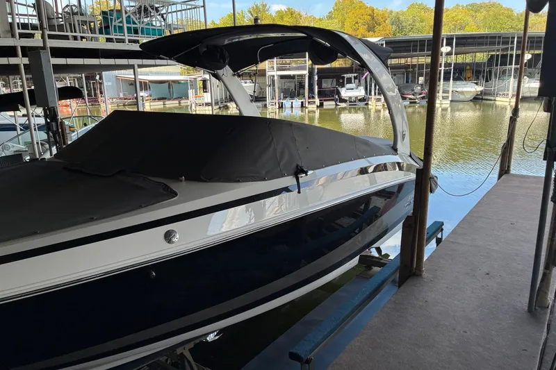 Slide: The Image of 2014 Regal 2500 Bowrider boat docked in a marina with covered seating. - 5