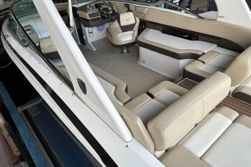 Slide: The Image of 2014 Regal 2500 Bowrider interior with beige seating and modern dashboard. - 8