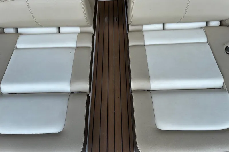 Slide: The Image of 2014 Regal 2500 Bowrider interior seating with beige and white upholstery. - 9