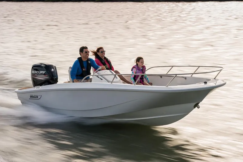 Slide: The Image of Manufacturer Provided Image: 2026 Boston Whaler 160 Super Sport boat cruising with three passengers on a sunny day. - 1