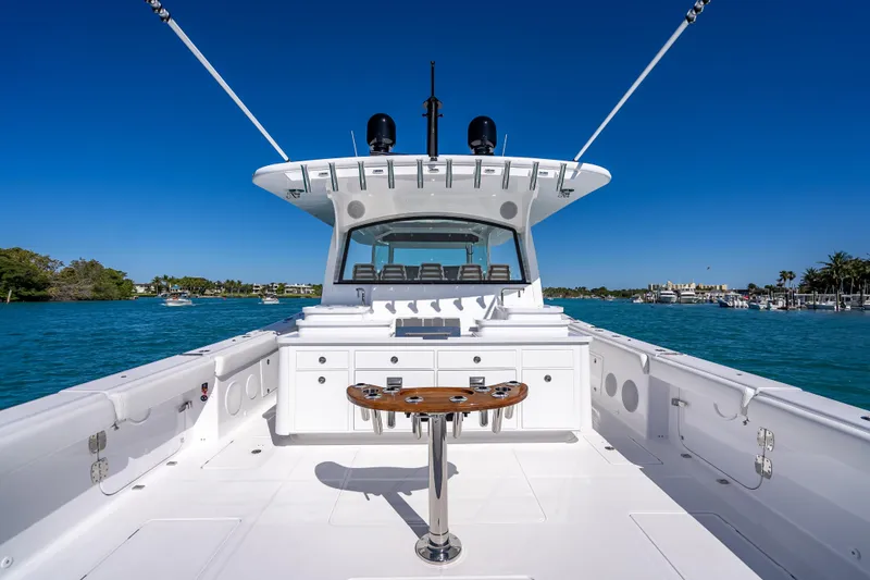 Slide: The Image of 2026 HCB 65 Estrella yacht on clear blue water, showcasing spacious deck and sleek design. - 10