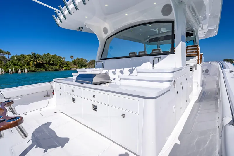 Slide: The Image of Luxurious 2026 HCB 65 Estrella yacht with sleek outdoor kitchen and seating area. - 12