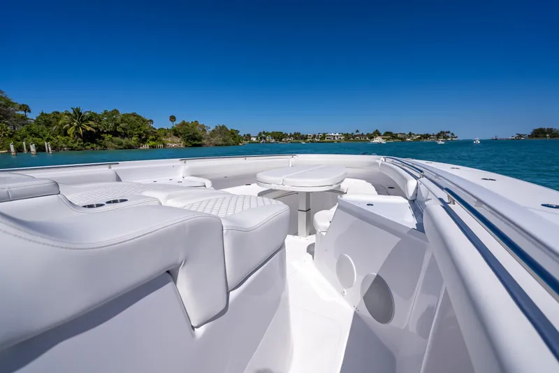 Slide: The Image of Luxurious 2026 HCB 65 Estrella boat interior with white seating, cruising on clear blue waters. - 21