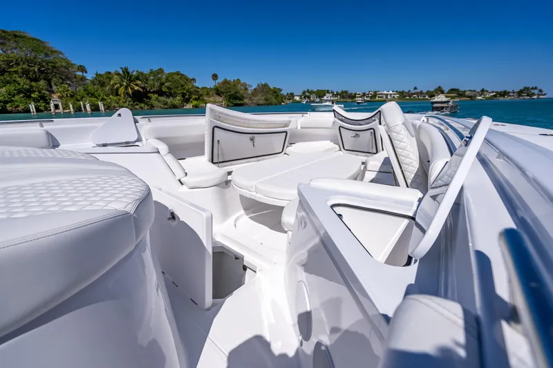 Slide: The Image of Luxurious 2026 HCB 65 Estrella boat interior with white seating and scenic ocean view. - 22