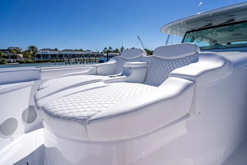 Slide: The Image of Luxurious seating on 2026 HCB 65 Estrella yacht with quilted white upholstery. - 23