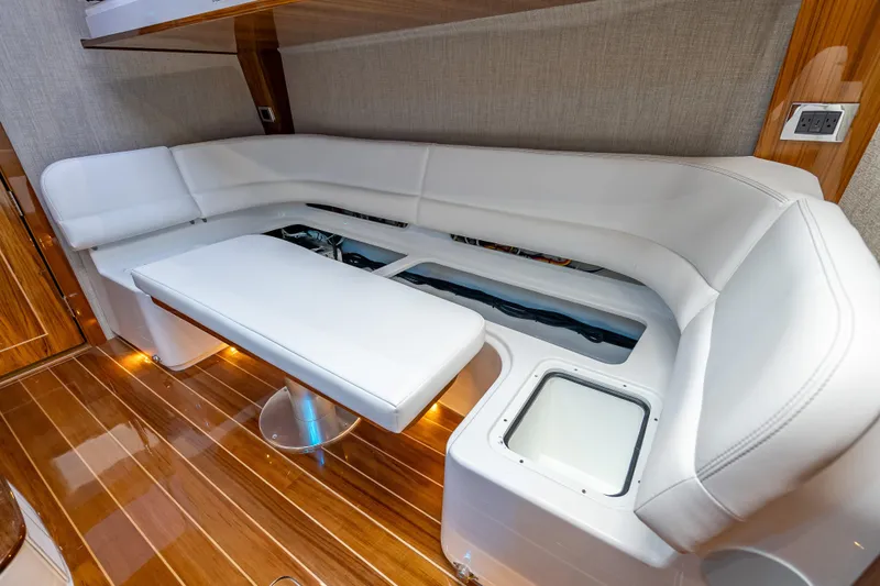 Slide: The Image of Luxurious interior of 2026 HCB 65 Estrella yacht with white seating and wooden flooring. - 26