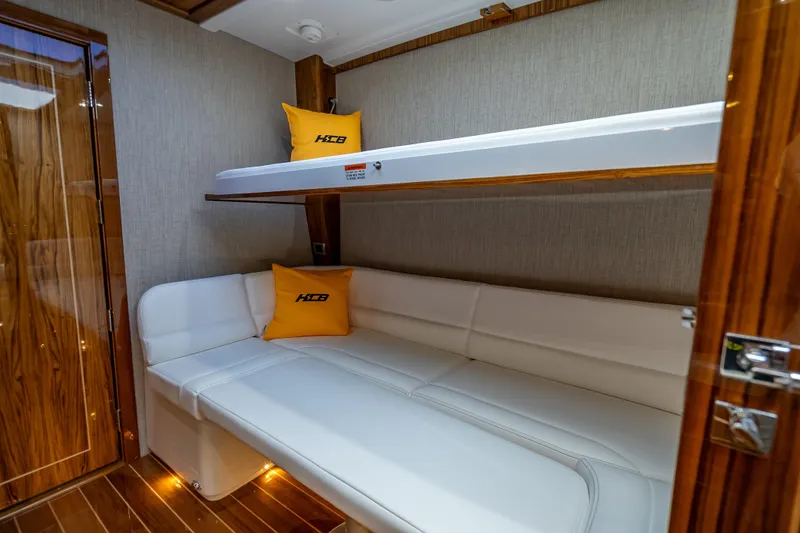 Slide: The Image of Luxurious interior of 2026 HCB 65 Estrella yacht with bunk beds and wood accents. - 28