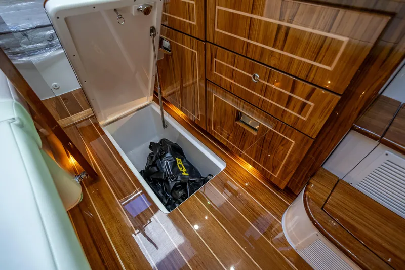 Slide: The Image of Luxurious interior of 2026 HCB 65 Estrella yacht with wooden flooring and storage compartment. - 29