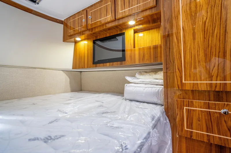 Slide: The Image of Luxurious cabin interior of 2026 HCB 65 Estrella with wood finish and cozy bedding. - 30