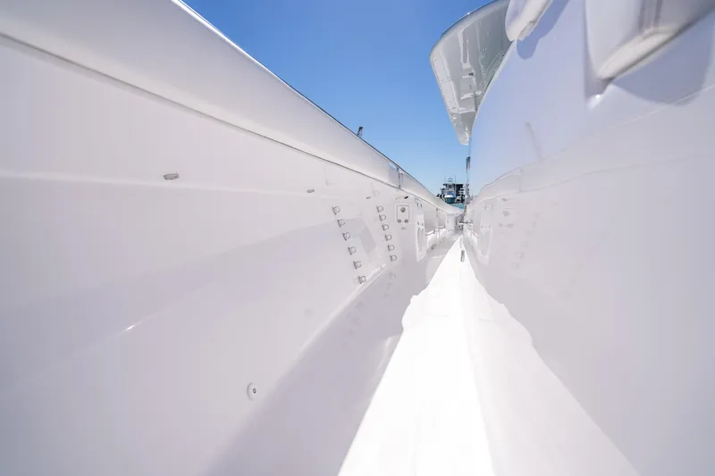 Slide: The Image of 2026 HCB 65 Estrella boat deck, sleek white design under clear blue sky. - 39