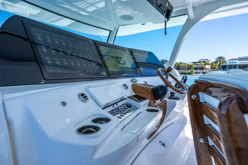 Slide: The Image of Helm of 2026 HCB 65 Estrella boat with advanced navigation displays and wooden steering wheel. - 6