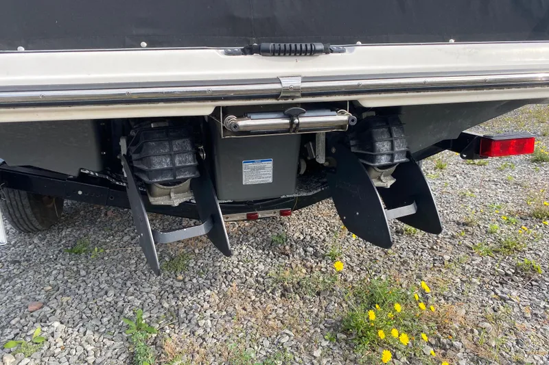 Slide: The Image of Rear view of 2015 Yamaha Boats 212X with dual jet drives on gravel. - 11