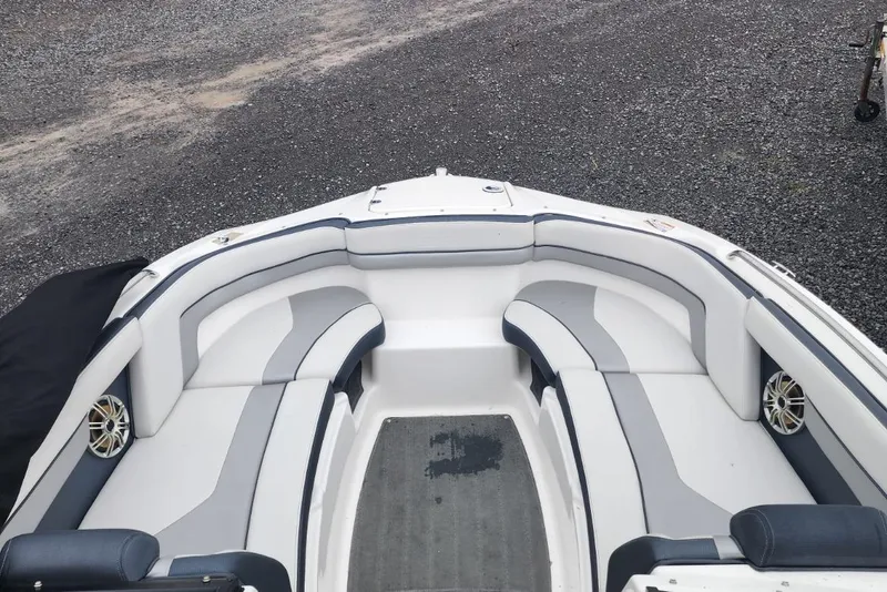Slide: The Image of 2015 Yamaha Boats 212X interior with gray and white seating, outdoor setting. - 14