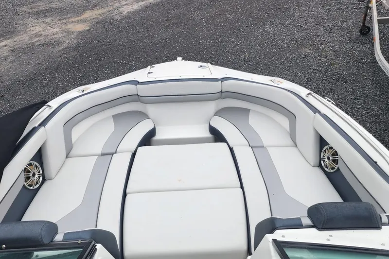 Slide: The Image of 2015 Yamaha Boats 212X interior with white and gray seating, featuring built-in speakers. - 17