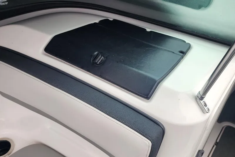 Slide: The Image of Interior detail of a 2015 Yamaha Boats 212X, featuring a black storage compartment. - 21