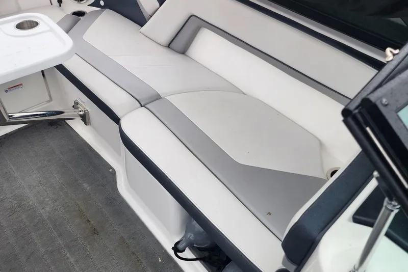 Slide: The Image of 2015 Yamaha Boats 212X interior seating with gray and white upholstery. - 28